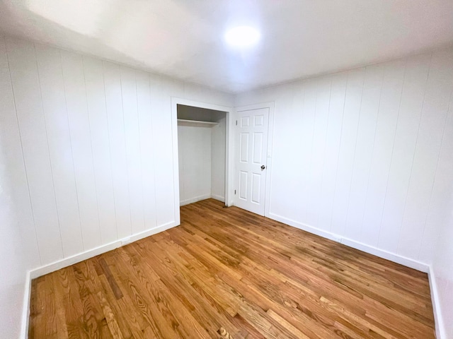 unfurnished bedroom featuring a closet and light wood-type flooring