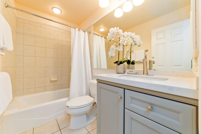 full bathroom with tile patterned flooring, toilet, vanity, and shower / tub combo with curtain