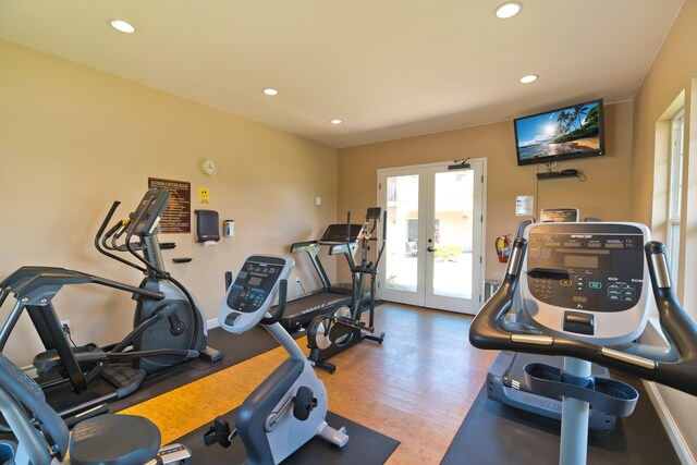 workout room featuring wood-type flooring and french doors