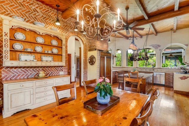 dining space with ceiling fan with notable chandelier and light wood-type flooring