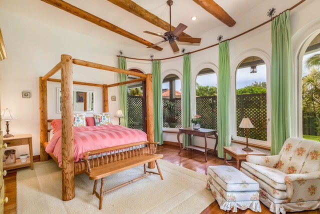 bedroom with ceiling fan, wood-type flooring, and beam ceiling