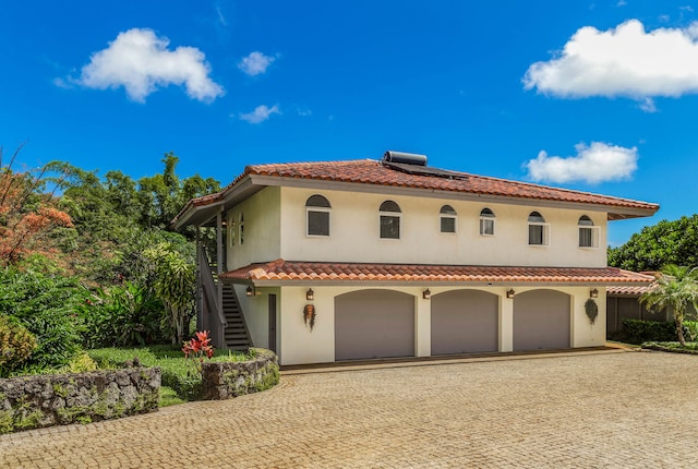 mediterranean / spanish home with a garage