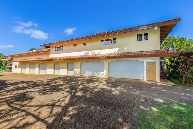 mediterranean / spanish house with a garage