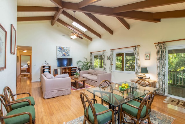 dining room with beamed ceiling, hardwood / wood-style floors, high vaulted ceiling, and ceiling fan