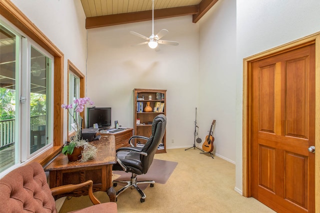 office space with carpet flooring, beam ceiling, ceiling fan, and high vaulted ceiling