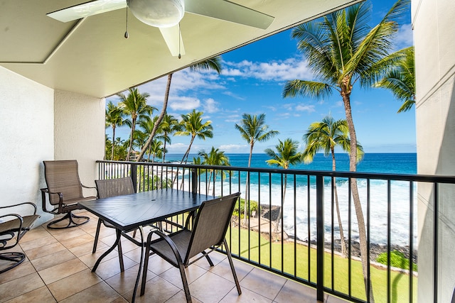 balcony with a water view and ceiling fan