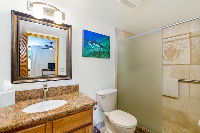 full bathroom featuring a tile shower, visible vents, toilet, and vanity