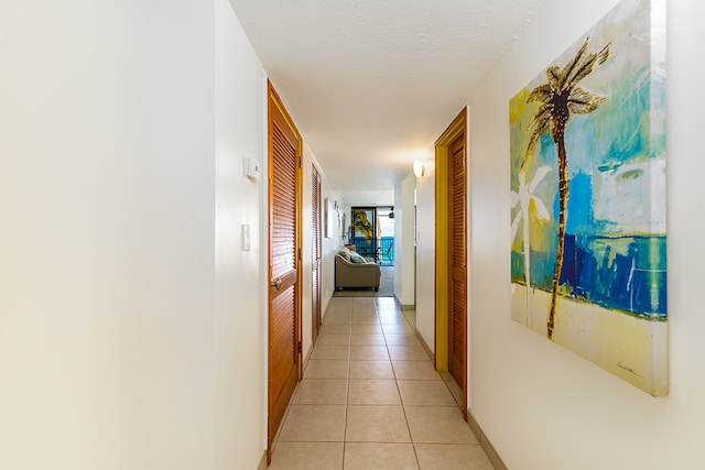 corridor featuring light tile patterned floors