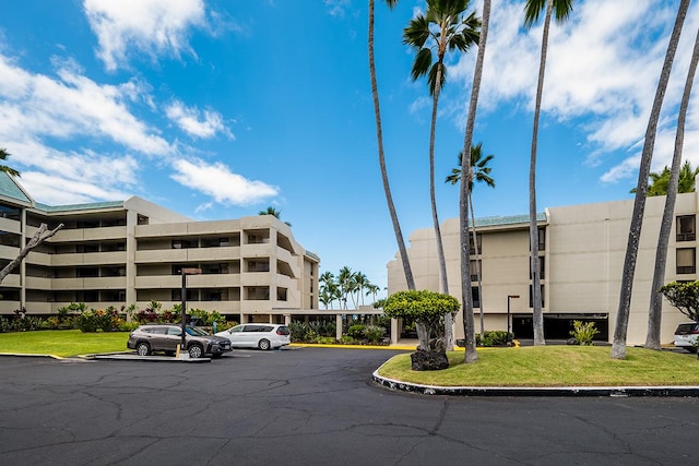 view of property featuring uncovered parking