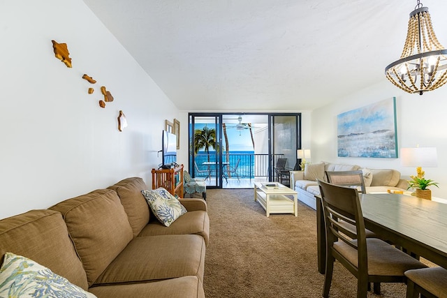 living area featuring a notable chandelier, carpet flooring, and expansive windows