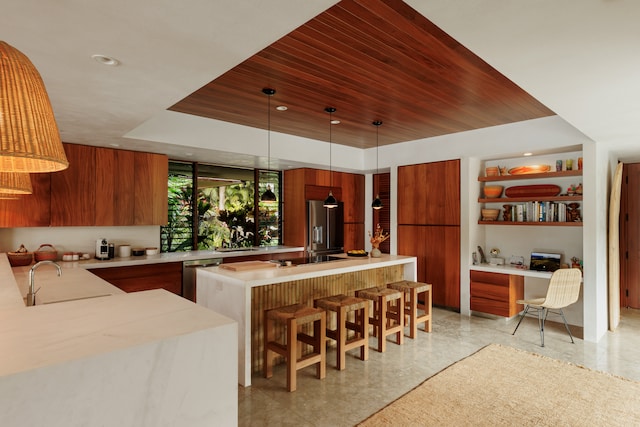 kitchen featuring sink, appliances with stainless steel finishes, wooden ceiling, and decorative light fixtures