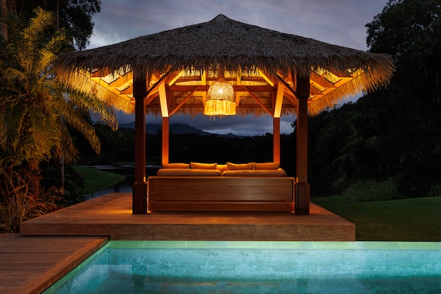 view of swimming pool featuring a deck, an outdoor living space, and a gazebo