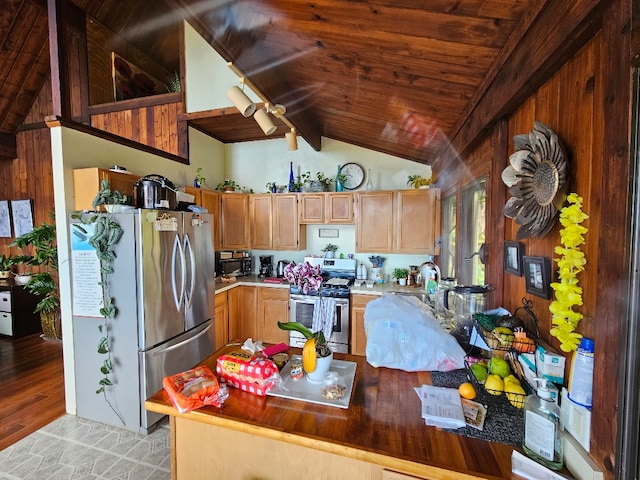 kitchen with stainless steel appliances, vaulted ceiling with beams, wooden ceiling, and ceiling fan