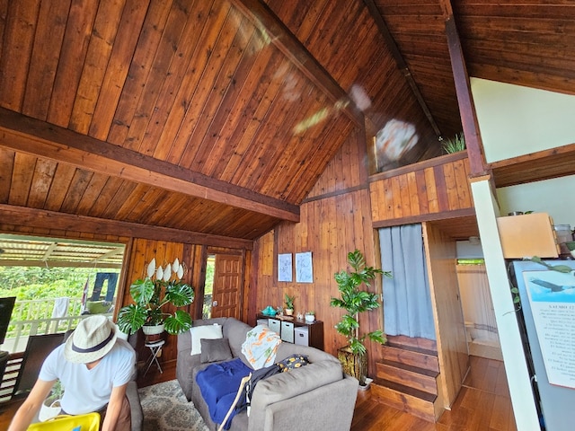 living room with hardwood / wood-style flooring, high vaulted ceiling, wooden ceiling, beamed ceiling, and wood walls