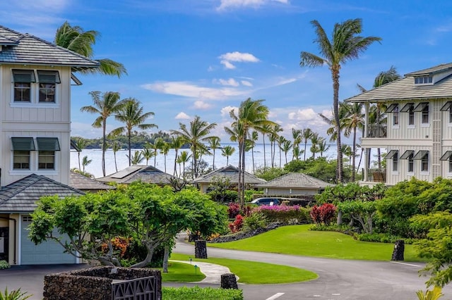 view of home's community featuring a yard and a water view