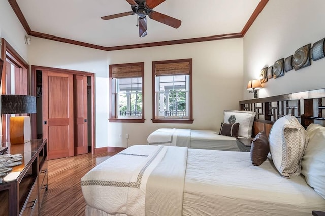 bedroom featuring wood-type flooring, ceiling fan, and crown molding