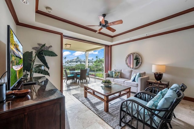 living room featuring a tray ceiling, ceiling fan, and crown molding