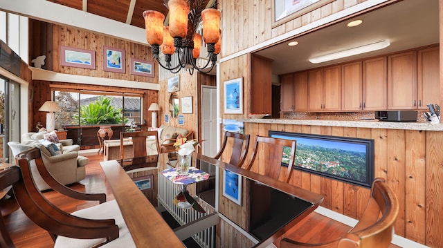 interior space featuring wood ceiling, wood-type flooring, wooden walls, and an inviting chandelier