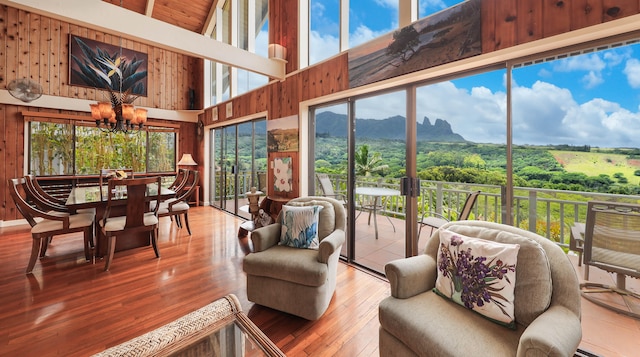 sunroom featuring a mountain view and a chandelier