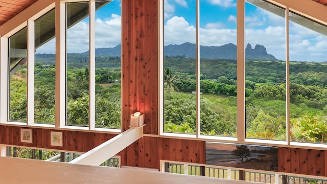 unfurnished sunroom featuring a mountain view and plenty of natural light