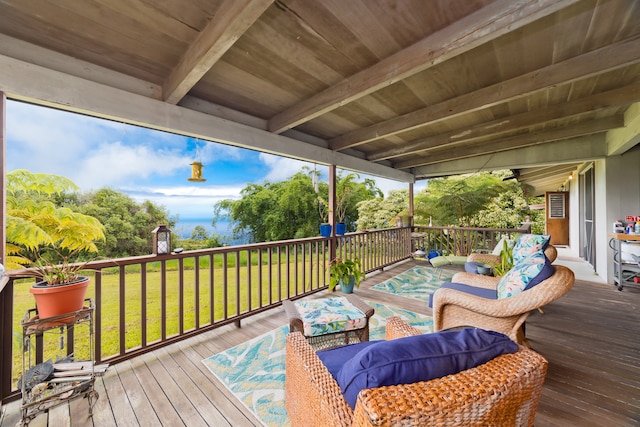 wooden terrace with a lawn