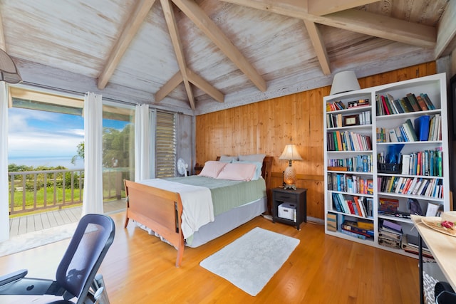 bedroom featuring vaulted ceiling with beams, light wood-type flooring, wooden walls, access to exterior, and wood ceiling