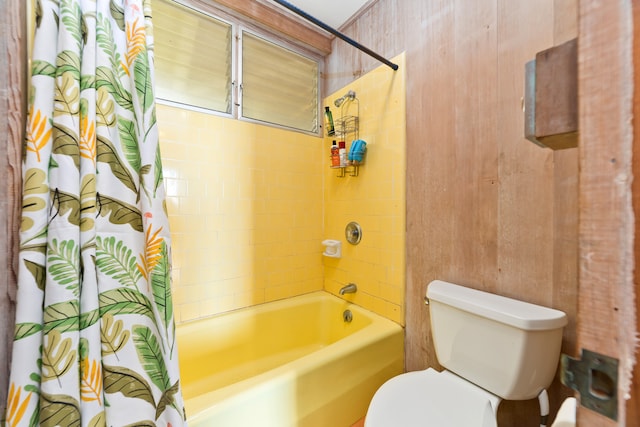 bathroom with toilet and shower / bath combination with curtain