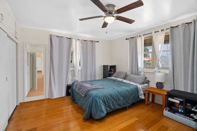 bedroom with ceiling fan and light hardwood / wood-style floors