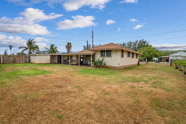 rear view of property with a lawn