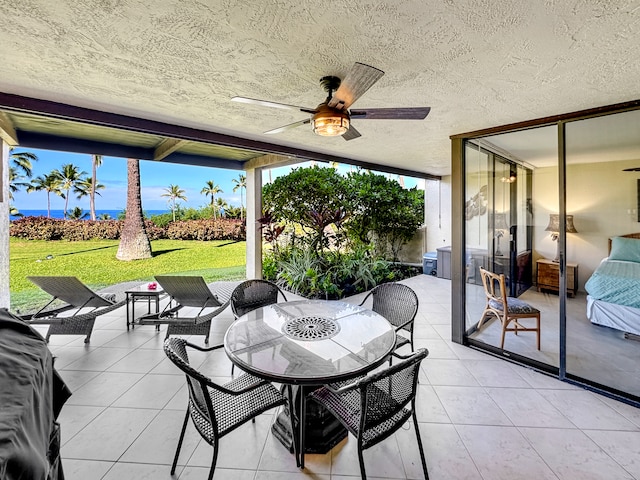 sunroom / solarium featuring ceiling fan