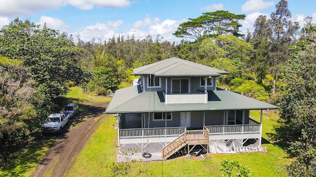 rear view of property with a lawn