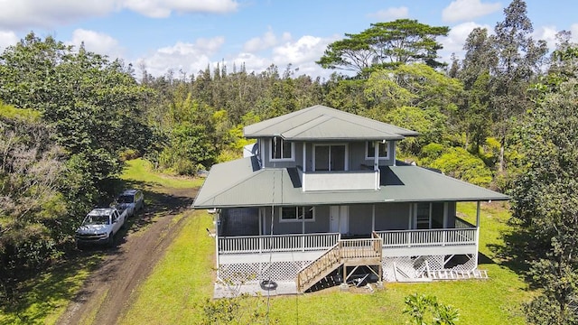 view of front of property with a porch, a front yard, and stairway