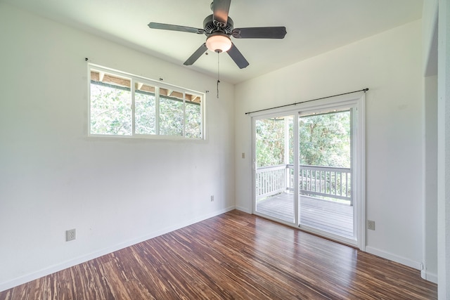 empty room featuring dark hardwood / wood-style flooring and ceiling fan