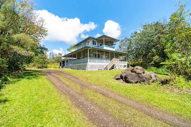 rear view of house with a yard