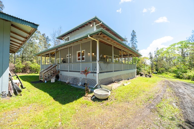 view of property exterior featuring covered porch and a lawn