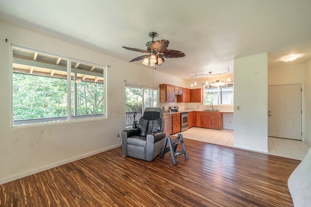 office area with sink, rail lighting, a healthy amount of sunlight, and light tile patterned floors