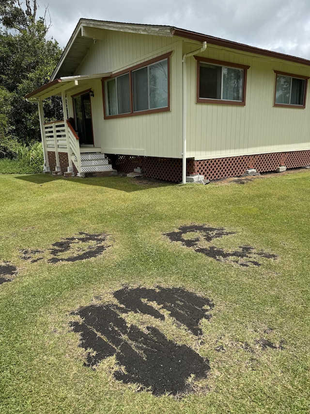 view of side of home featuring a lawn