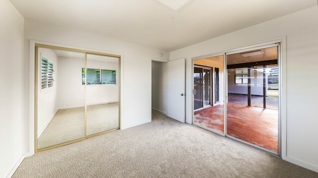 unfurnished bedroom featuring carpet and a closet