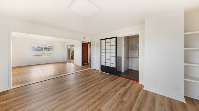 unfurnished living room with wood-type flooring