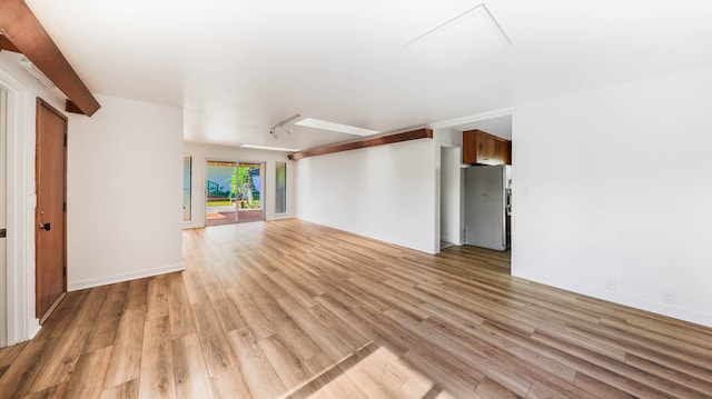 unfurnished living room featuring hardwood / wood-style flooring