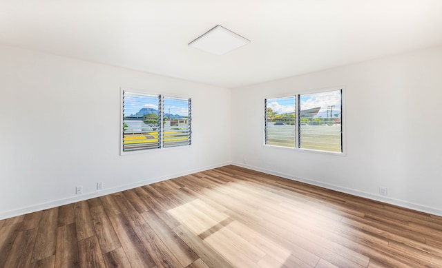 spare room with hardwood / wood-style flooring