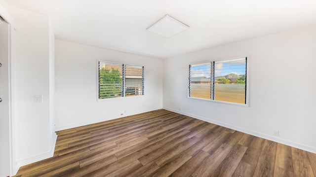 spare room with dark wood-type flooring