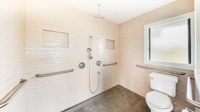 bathroom with plenty of natural light, tile walls, and toilet