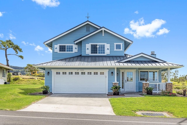 view of front facade featuring a garage, a front lawn, and covered porch