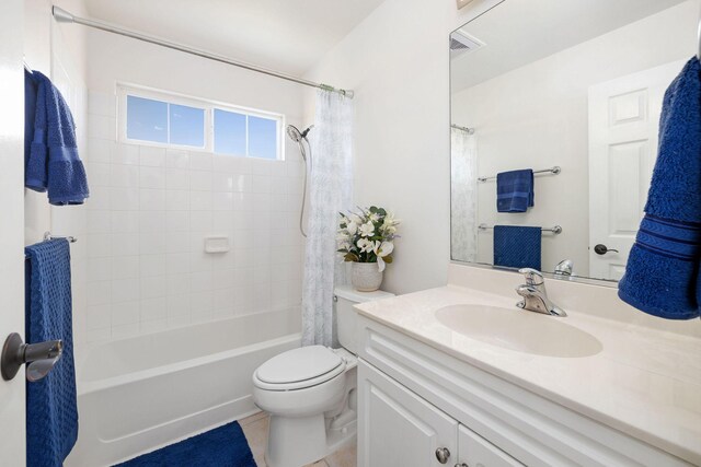 full bathroom with vanity, shower / bath combo, tile patterned flooring, and toilet