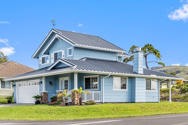 view of front of home featuring a porch, a garage, and a front lawn