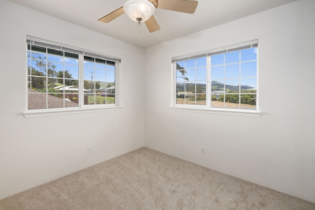 carpeted empty room with ceiling fan