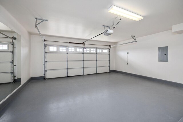 garage featuring a garage door opener and electric panel