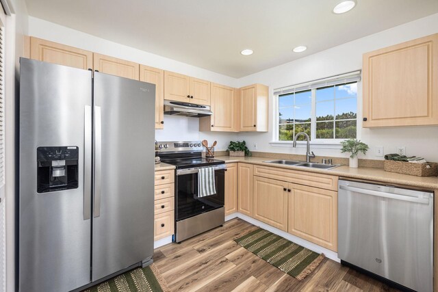 kitchen with light hardwood / wood-style floors, sink, light brown cabinets, and stainless steel appliances