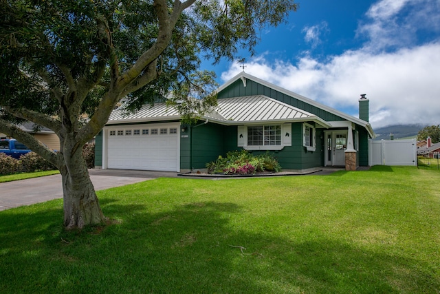 view of front of property featuring a garage and a front lawn